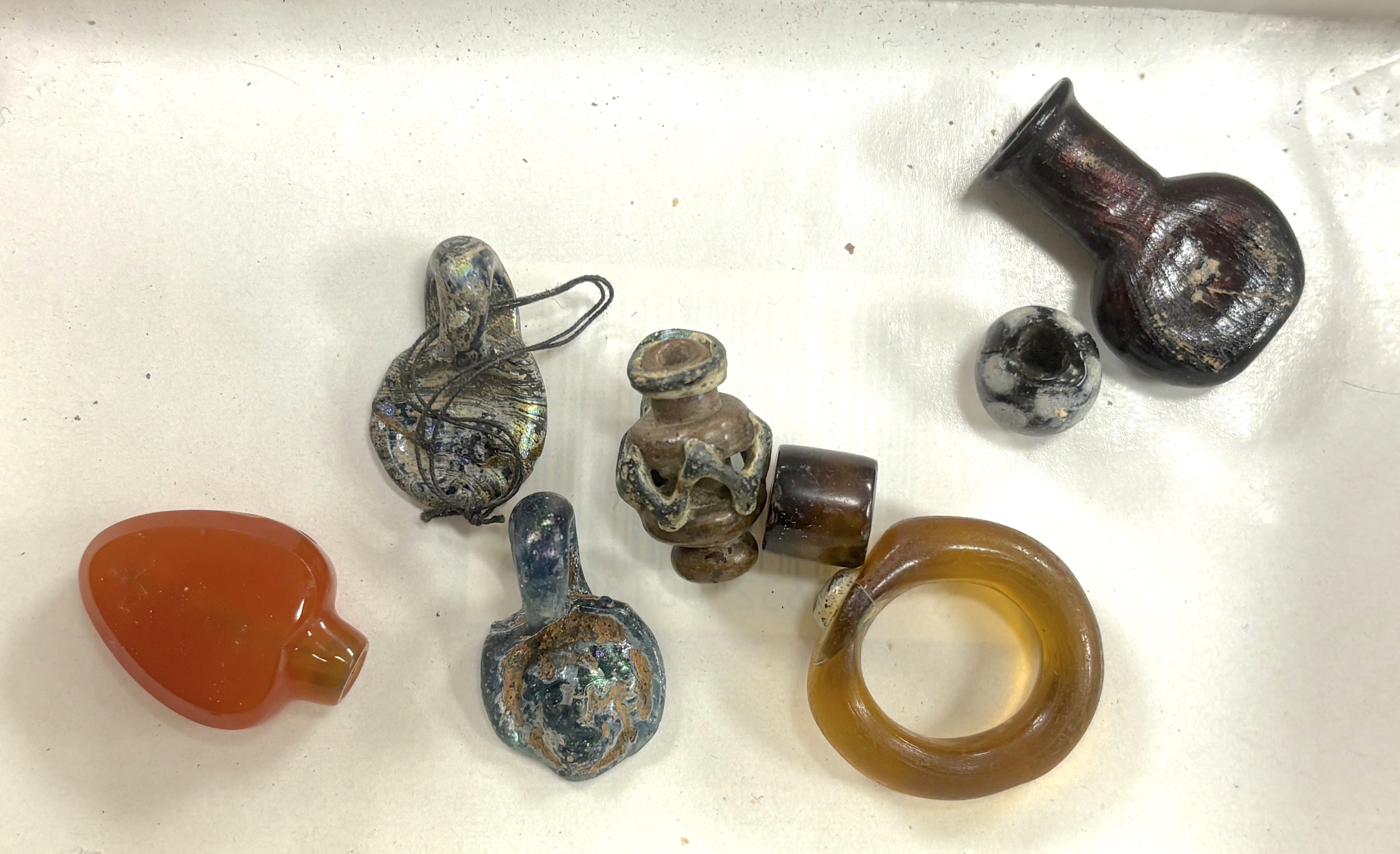 Miniature antiquities, including glass beads and miniature vessels, some possibly thought to be Roman